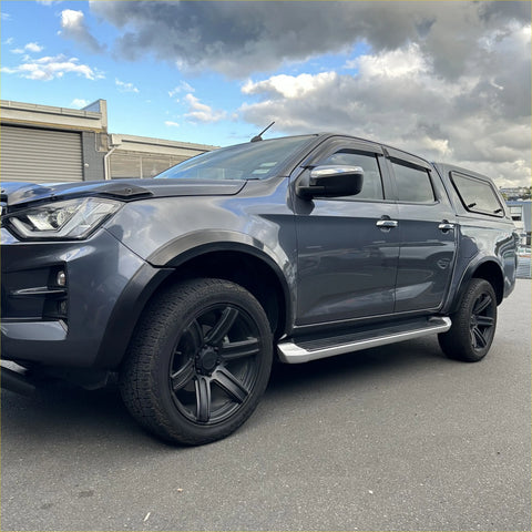 Dark gray metallic isuzu d-max 2021-2023 with matte black 4-inch smooth style fender flares and black alloy wheels