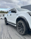 White isuzu d-max 2024 with matte black 4-inch fender flare, black wheels, and side steps shown from the back side