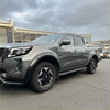 Gray metallic nissan navara with matte black 4-inch fender flare and black alloy wheels in rugged modern style