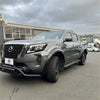 Gray metallic nissan navara 2021 with matte black 4-inch fender flare and rugged front bumper and black accents