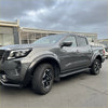 Gray metallic nissan navara 2021+ with matte black 4-inch fender flare style and black alloy wheels with side steps