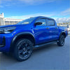 Vibrant blue toyota hilux with matte black 4-inch fender flares black alloy wheels and side steps 2021-2024 sr sr5