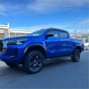 Vibrant blue toyota hilux 2021-2024 sr sr5 with matte black 4-inch fender flare and rugged off-road tires