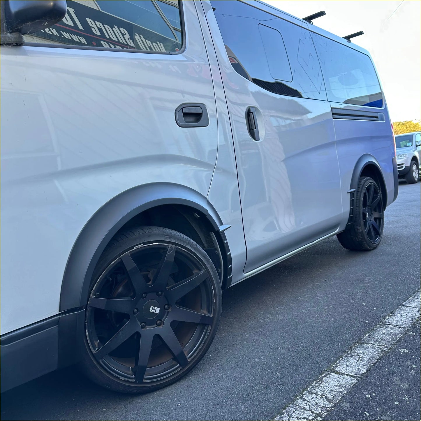 Silver nissan nv350 van with black alloy wheels and matte sport style fender flare for nv350 caravan 2012-current