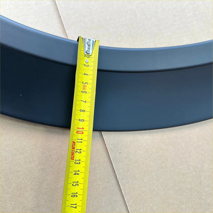 Dark blue curved metal fender flare for nissan nv350 caravan 2012-current sport style matte being measured with tape