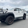 White toyota hilux rocco with black lychee texture bolt-on fender flares wheels and side steps from 2018 to 2020