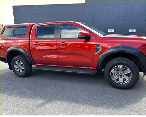 Red ford ranger 2022 xlt sport with black bolt style fender flares and matching tonneau cover from the back side
