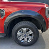 Black plastic bolt style fender flare on red 2022 ford ranger xlt sport model pickup truck