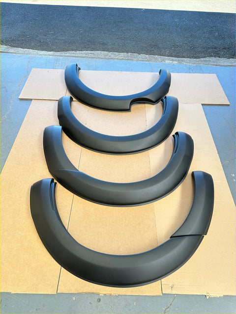 Black matte finish fender flares for ford ranger px1 2012-2015 arranged in descending size on cardboard