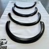 Black glossy finished fender flares for ford ranger px2 2016-2018 arranged by size on a white protective sheet