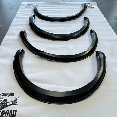 Black glossy finished fender flares for ford ranger px2 2016-2018 arranged by size on a white protective sheet
