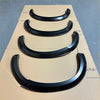 Black glossy finish fender flare set for isuzu d-max 2016-2020 smooth style matte black arranged on cardboard