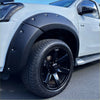 Black matte finish plastic fender flare with silver bolts mounted on white isuzu d-max 2016-2020 pickup truck