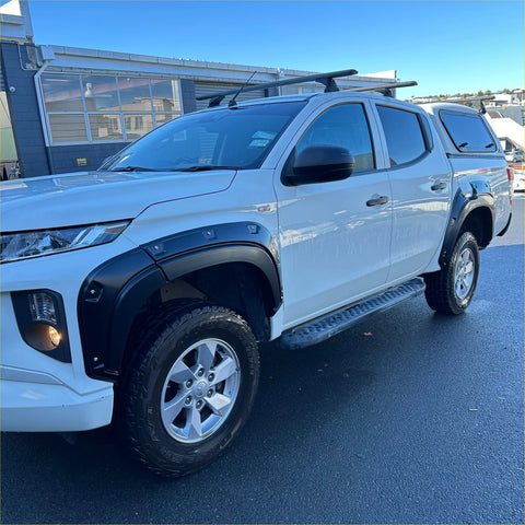 White mitsubishi triton with matte black bolt style fender flares and roof rack from 2019 to 2023 model