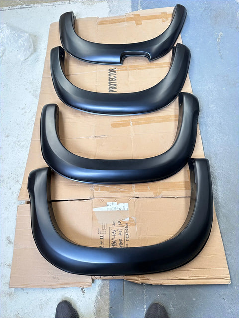 Black matte finish smooth style fender flares for Mitsubishi Triton 2019-2023 shown from the back side