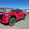 Vibrant red mitsubishi triton 2019-2023 with smooth style matte black fender flares and rugged off-road tires