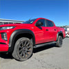 Vibrant red mitsubishi triton 2019-2023 with smooth style matte black fender flares and rugged off-road tires
