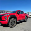 Vibrant red mitsubishi triton 2019-2023 with smooth style matte black fender flares and rugged off-road tires
