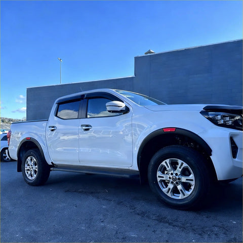 White isuzu d-max pickup truck with chrome wheels and black matte fender flare nissan navara 2021+ oem style