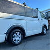 White toyota hiace van with matte black sport style fender flares black side steps and roof racks from 2005-2019