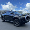 Black toyota hilux 2021-2024 sr sr5 bolt style matte black fender flare on glossy black pickup with black alloy wheels