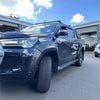 Black matte fender flare for toyota hilux 2021-2024 sr sr5 with bolt style on a glossy black off-road pickup truck