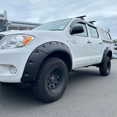 White toyota hilux pickup with black textured bolt style fender flares and rugged tires for 2005-2012 vigo models