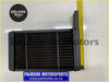 Black plastic Ford Capri MK1 & MK2 heater core radiator with vertical slats and pipe on the right side back view