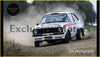 White and red ford escort mk2 rally car with black racing stripes featuring alloy front spoiler and quaife decal