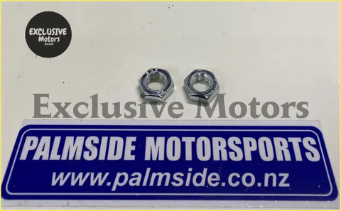 Two chrome hexagonal nuts on a blue and white palmside motorsports sign for ford escort mk2 2.9 road car steering rack rhs