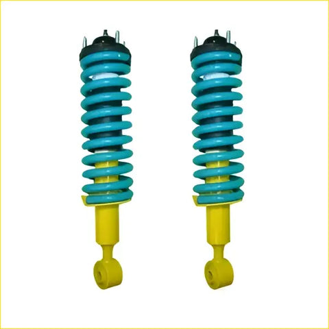 A pair of vibrant teal and yellow coil over shock absorbers with black mounts for ford ranger px3 by dobinsons