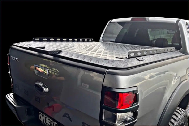 Back view of a silver metallic ford ranger tomahawk aluminium hardlid with textured diamond plate finish and led light bars