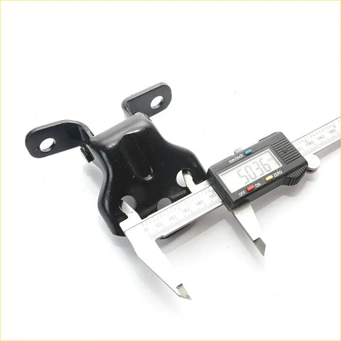 Black metal car mount bracket being measured with digital caliper for front door hinges set mazda capella 626 85-87