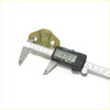Digital caliper with black body and silver jaws measuring a yellowish-green front door latch striker set for toyota hilux