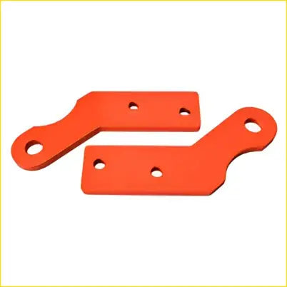 Orange plastic mounting brackets with circular holes and rectangular cutouts for Land Rover Discovery tow recovery kit