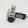 A digital caliper measuring a metallic front wheel brake cylinder with brass fittings and black rubber seals for nissan datsun 520