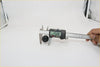 Black cylindrical front window washer nozzle for Nissan measured 25.80 mm with a digital caliper