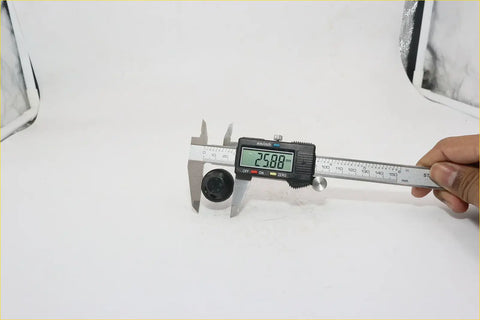 Black cylindrical front window washer nozzle for Nissan measured 25.80 mm with a digital caliper
