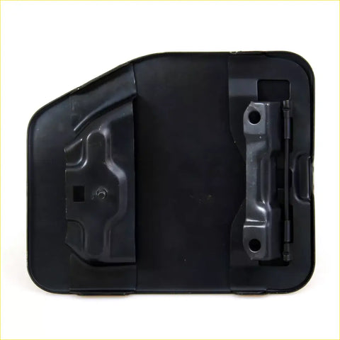 Back side of black plastic fuel door cover with molded contours and metal hinge for Toyota Hilux 1988-1997