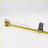 Yellow measuring tape with black markings beside a black fuel tank gauge sending unit for Nissan Datsun 720 Ute 1980-1986