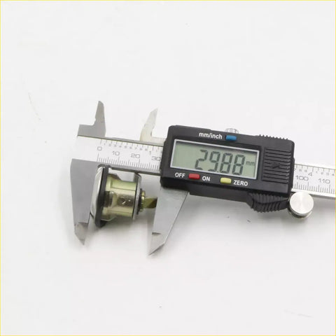 Metallic gas filler lock ignition cylinder being measured with digital caliper for nissan d21 king cab navara pathfinder
