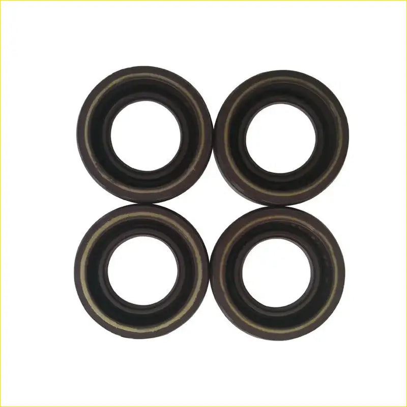 Four black rubber spark plug gaskets with metallic inner rings arranged in a square for toyota carina 7afe