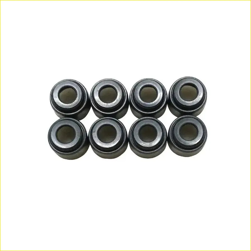 Eight black metal valve stem oil seal bearing cups arranged in two rows for gasket pro cd20 nissan sunny y10