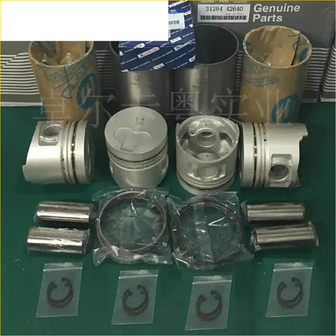 Silver metallic engine pistons with ring grooves and valve recess displayed with rings and clips for kia k2500 d4bh engine