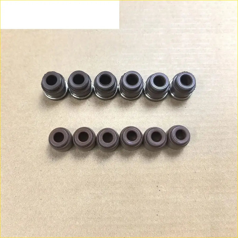 Ten black rubber gaskets with metallic silver rings arranged in two rows for nissan 300 zx maxima ii valve stem oil seal