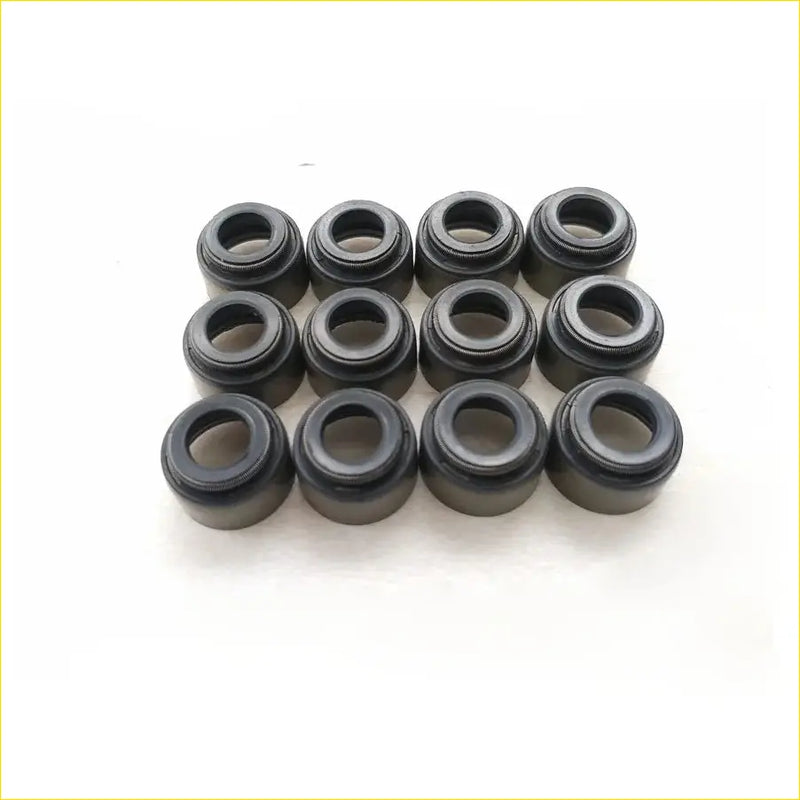 Black rubber gasket seals arranged in a grid for gasket pro toyota landcruiser coaster diesel engine valve stem oil seal
