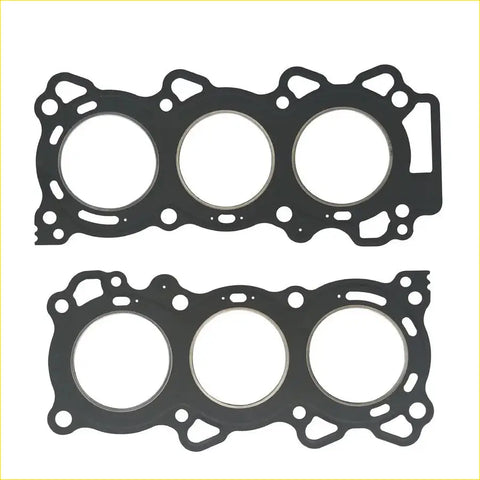Black rubber head gasket with three circular openings and intricate cutouts for vq25de nissan maxima engine mounting