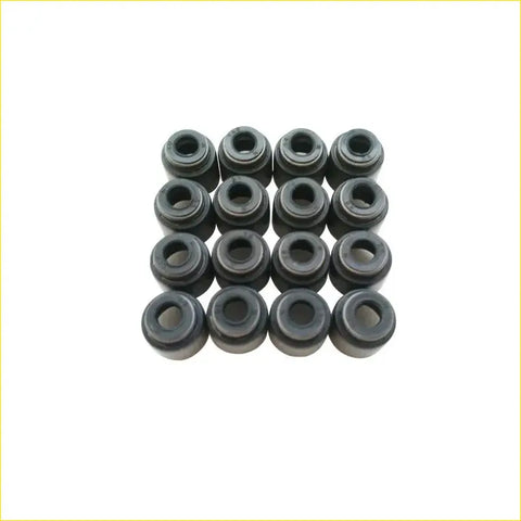 Black rubber valve stem oil seals arranged in a grid for nissan cabstar gasket pro zd30 zd30ddti 16pcs set
