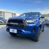 Vibrant blue toyota hilux 2021-2024 sr sr5 with bold black rugged off-road grille for tough use