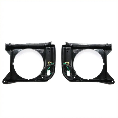 Black plastic headlight bezels with integrated wiring harnesses for toyota hilux 2wd models 1978-1983 shown from back side